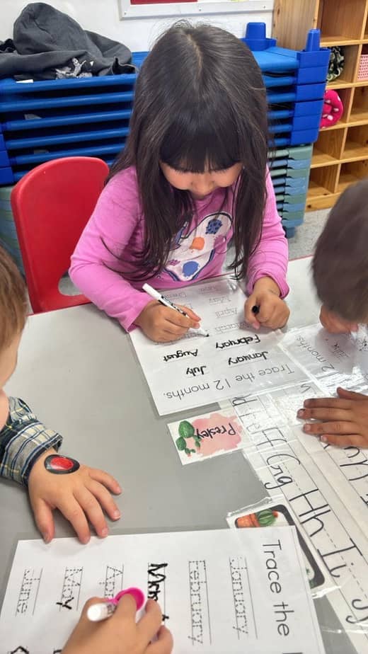 Child practicing handwriting worksheets at Lil’ Patriots Academy, preparing for kindergarten readiness and advanced preschool learning.