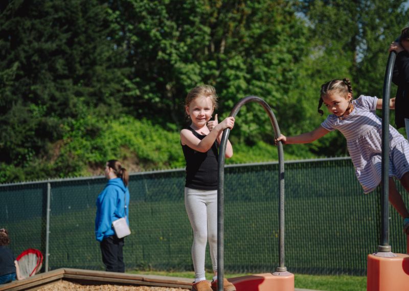 Children playing outdoors at Lil’ Patriots Academy in Puyallup, where dedicated teachers and childcare careers support early education.