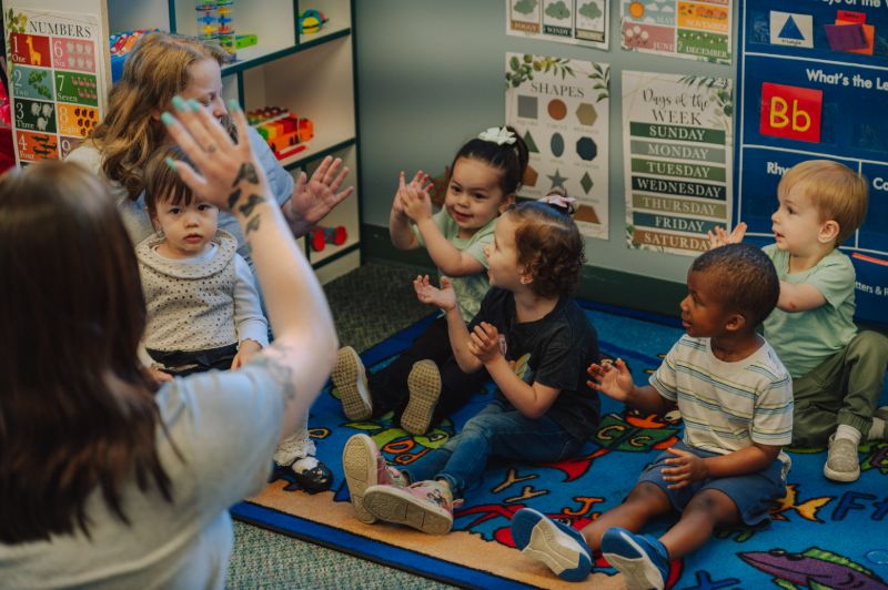 Group circle time and cooperative learning at Lil Patriots Academy, showing the collaborative environment families seek in daycares in puyallup washington.