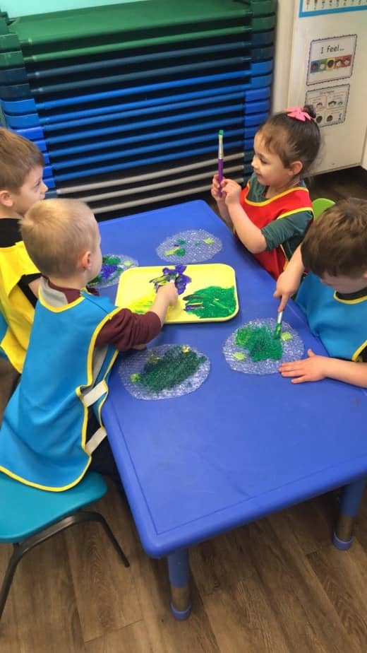 Children painting in a Pre-K classroom at Lil’ Patriots Academy, engaging in science-inspired art activities as part of the Pre-K Puyallup program.