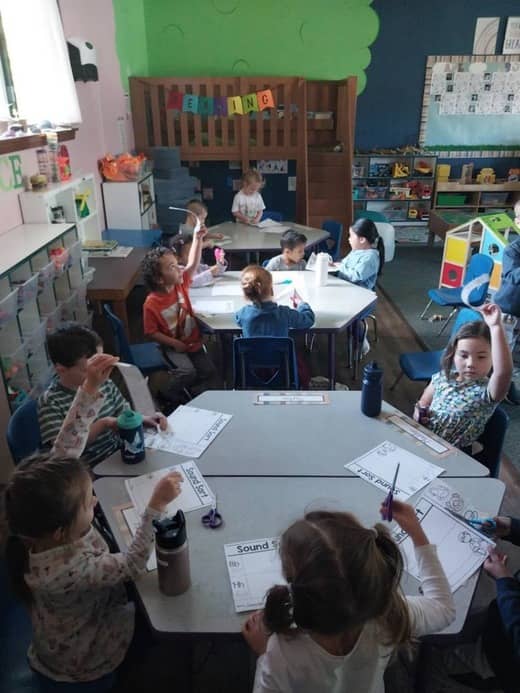 Children engaged in group learning activities inside Lil’ Patriots Academy, a preschool with Spanish immersion and Pre-K alternative program.