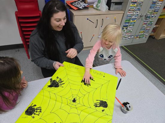 Teacher interacting with a child at Lil' Patriots Academy in Puyallup, demonstrating our individualized, play-based childcare approach.